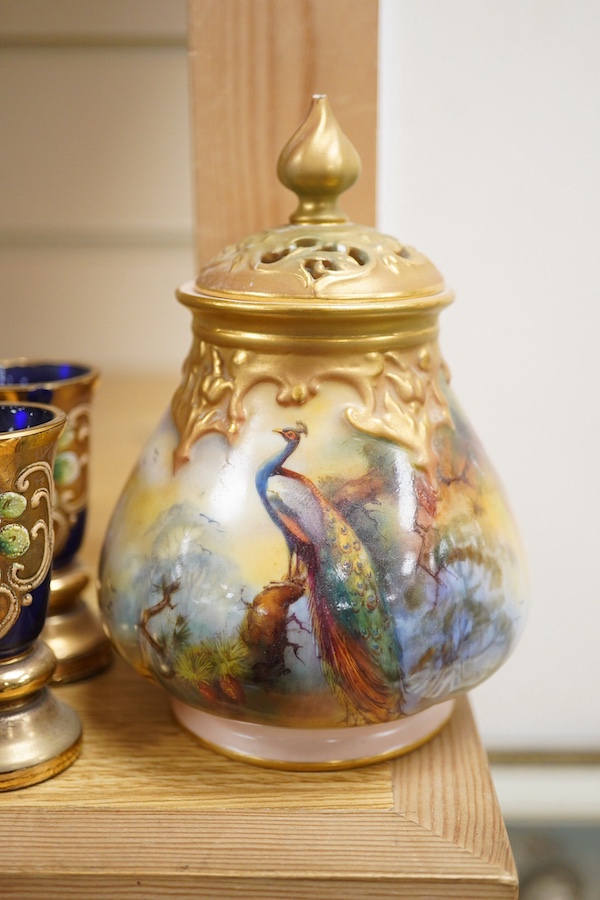 A Royal Worcester peacock painted jar and cover and a Bohemian blue glass decanter and six glasses, with gilt and enamel decoration, decanter 26cm high including stopper. Condition - finial to Worcester pot cover chipped